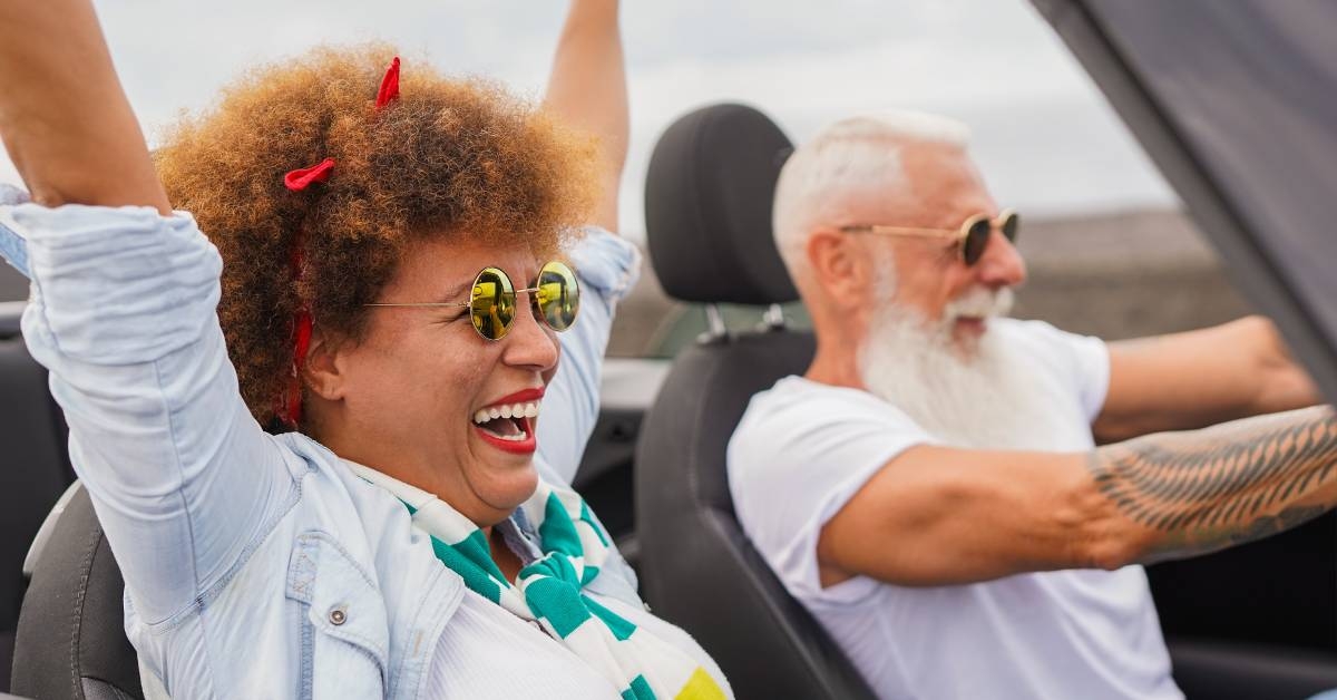Happy senior couple having fun during road trip travel vacation