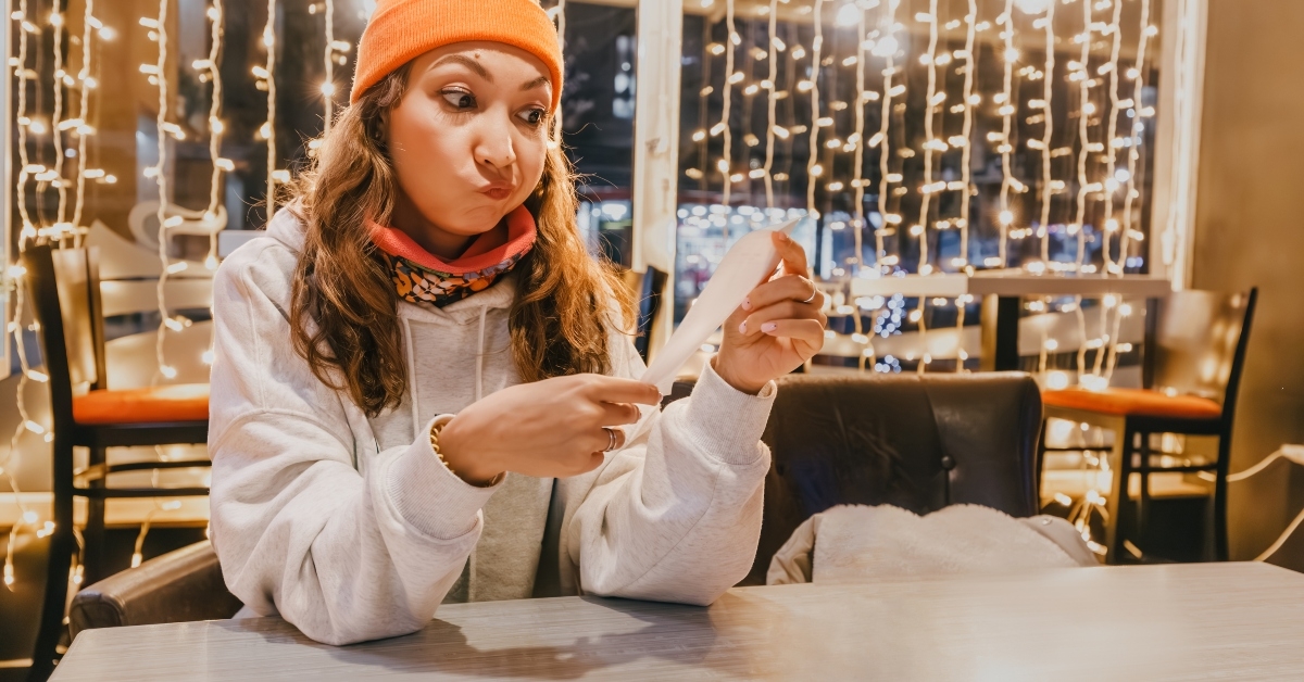  woman scrutinizes the bill