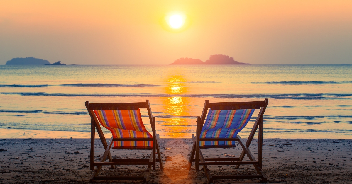 Pair of beach loungers at sunset