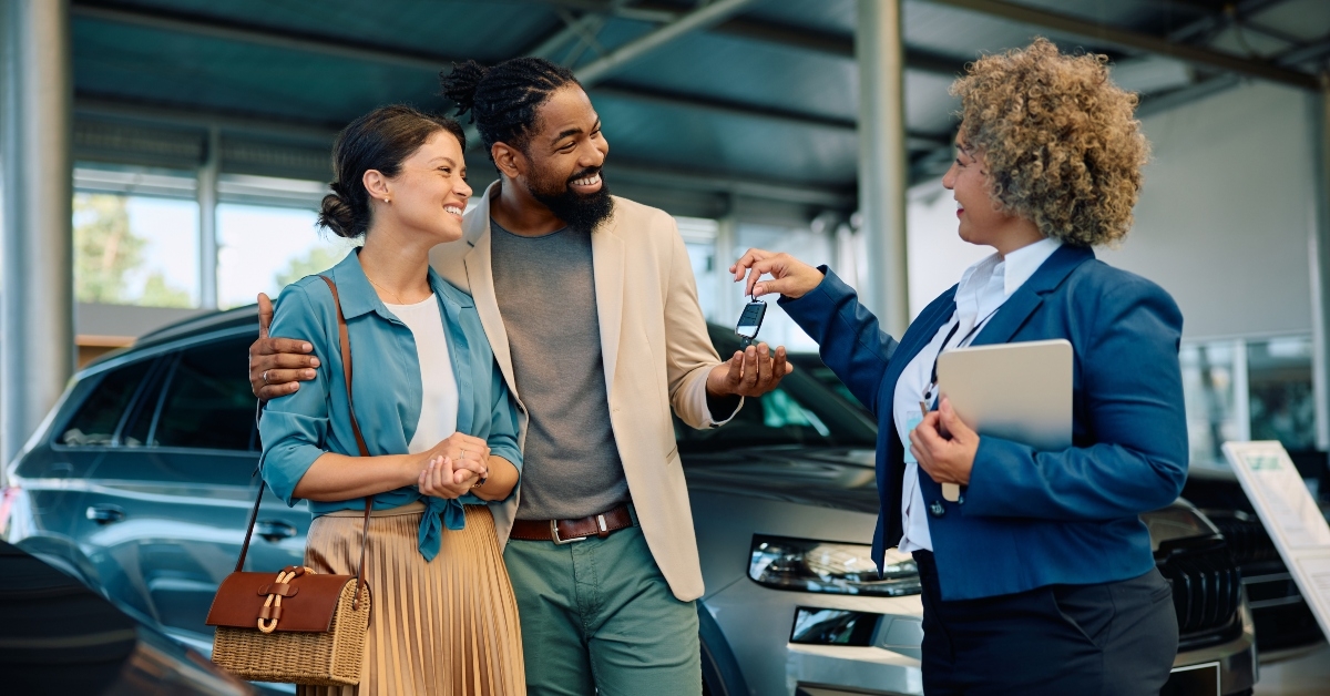 happy multiracial couple receiving keys
