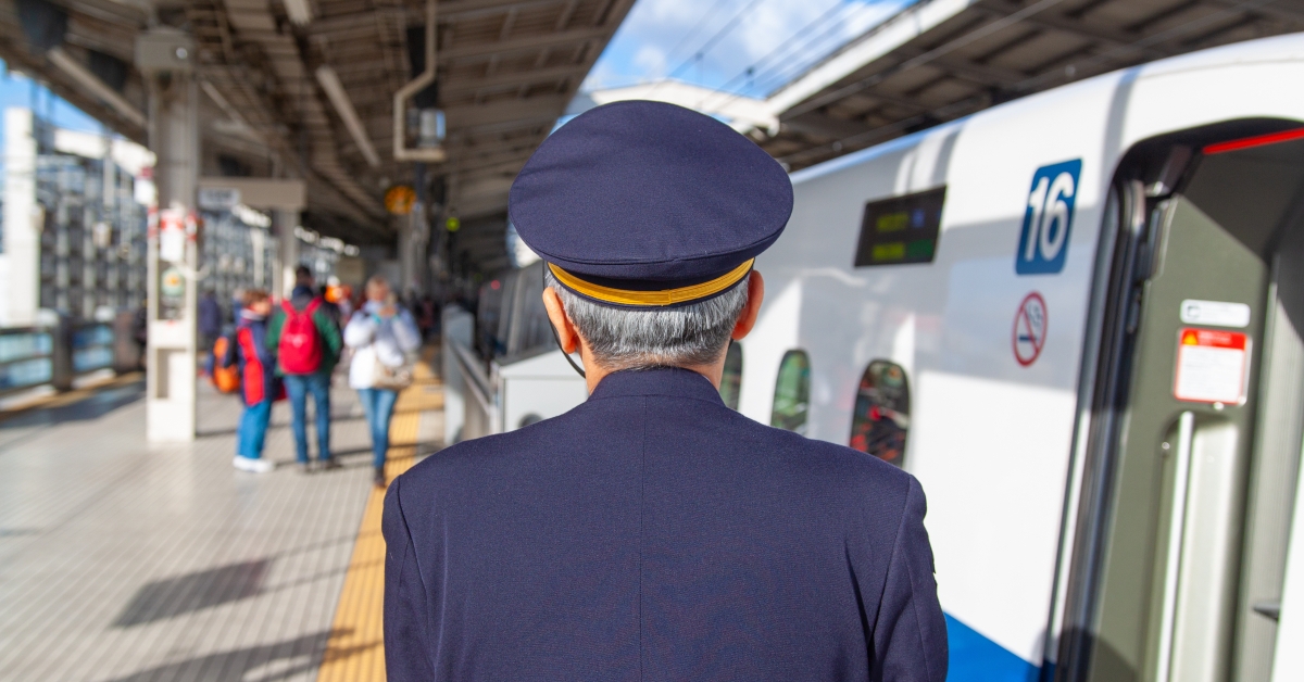 bullet train conductor checks the platform