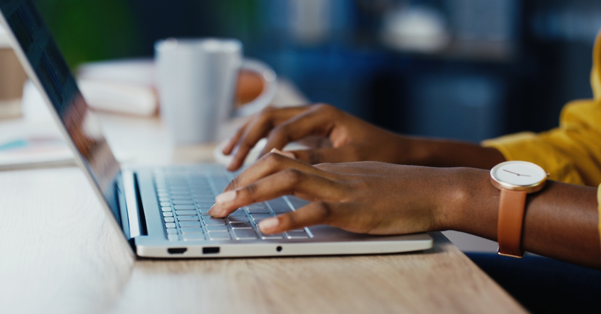 female hands typing on laptop