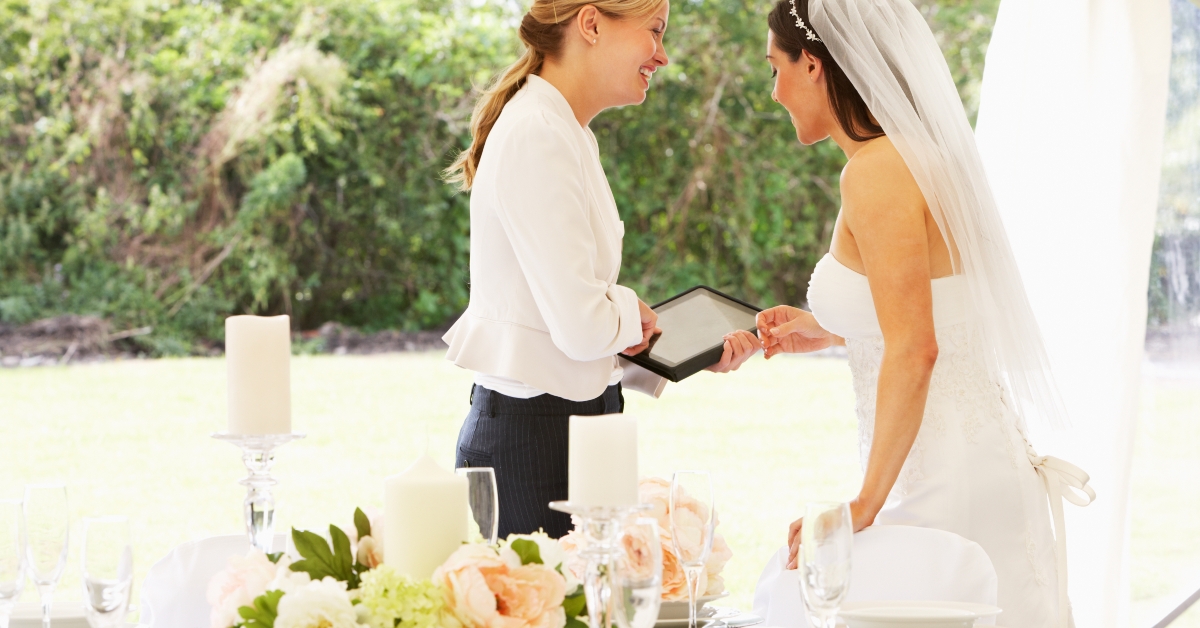 bride with wedding planner in marquee 