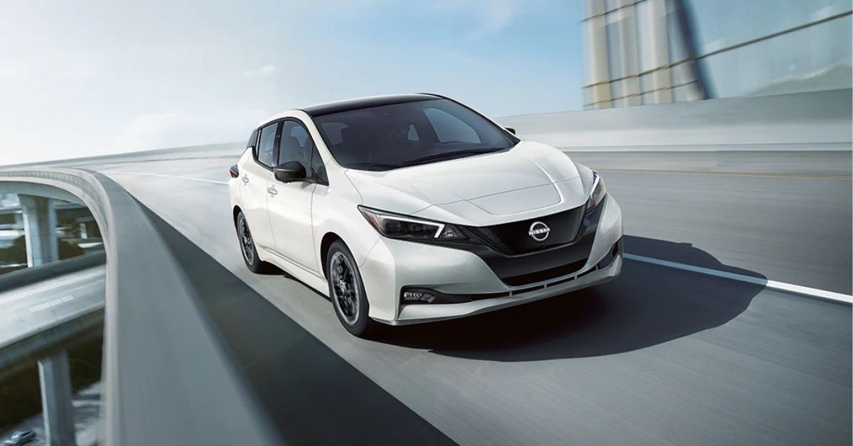 a white nissan leaf on the road