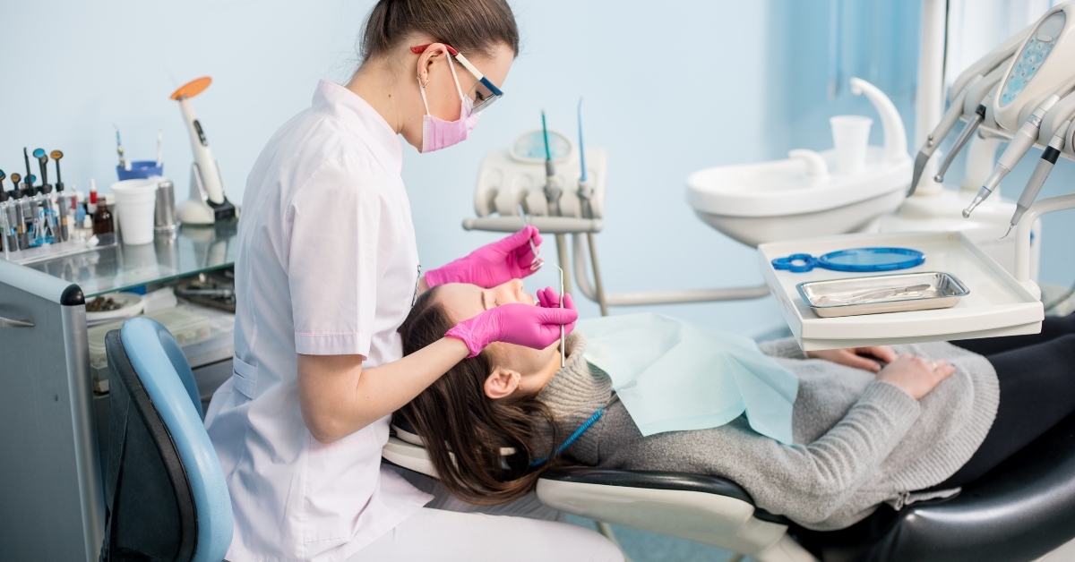 female dentist with dental tools
