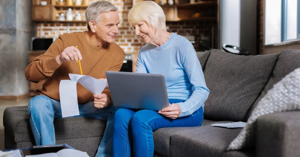 elderly couple sitting together and smiling
