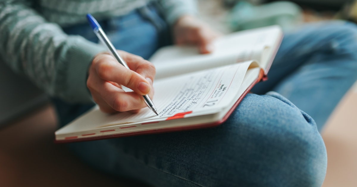writes notes in notebook