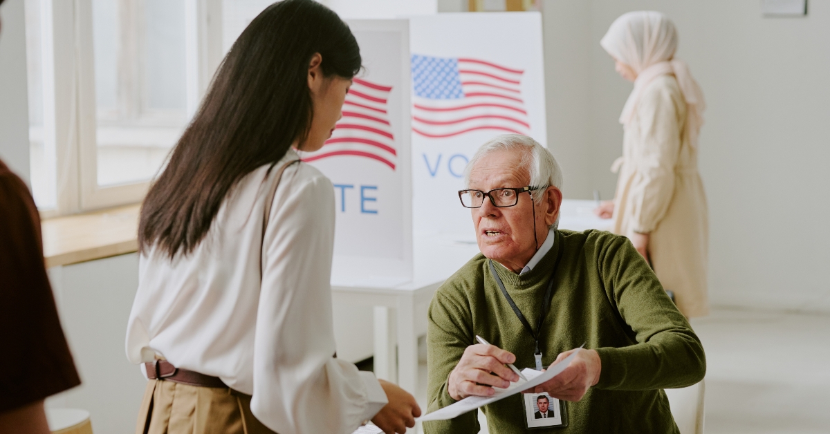 Senior Caucasian electoral district worker sitting