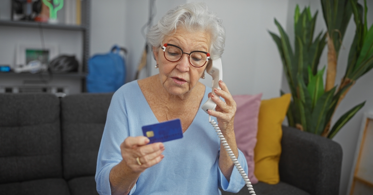 elderly woman holding credit card