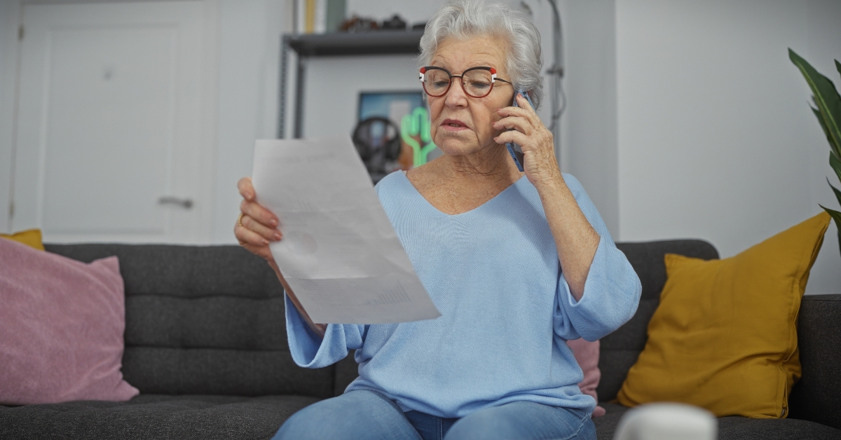 senior woman indoors reading document