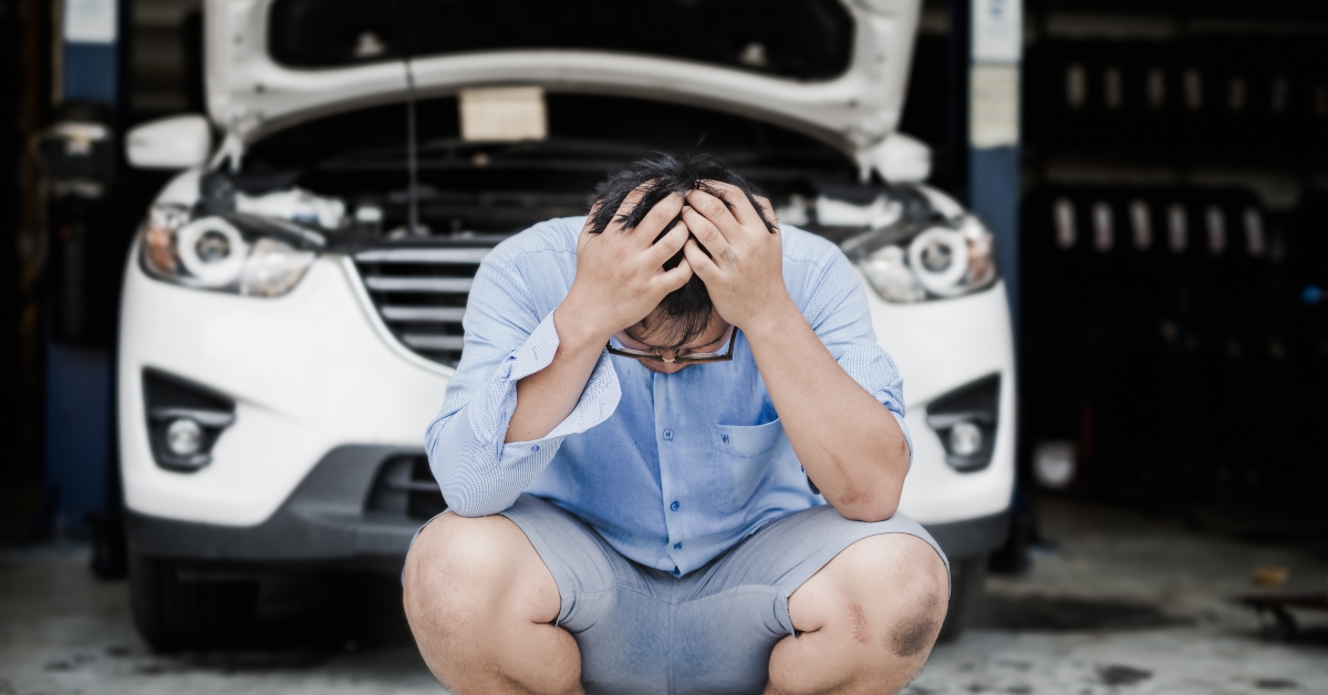 man stressed by the cost of repairing the car