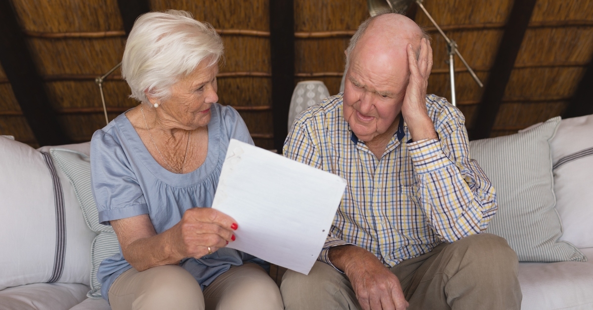 worried senior couple discussing over medical bills
