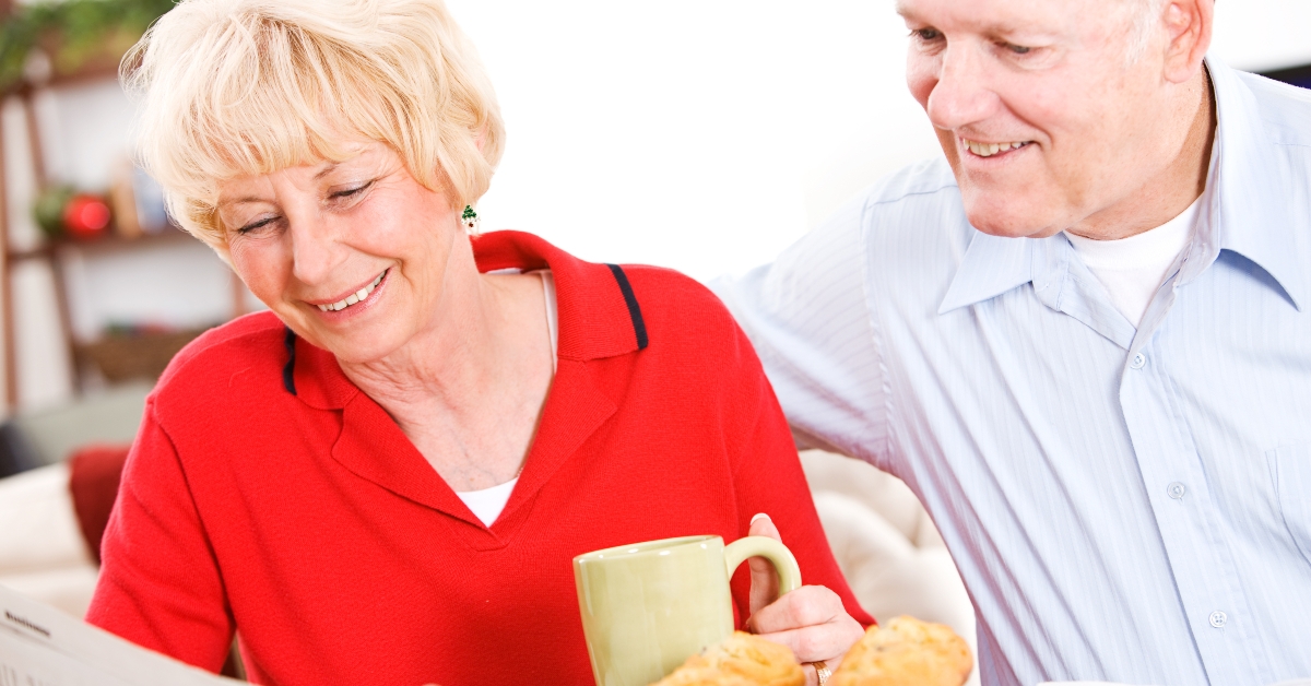 Couple Looking At Newspaper