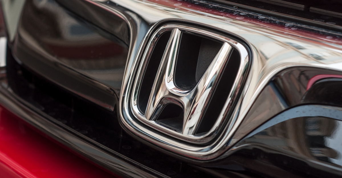 Closeup of Honda logo on red Honda civic