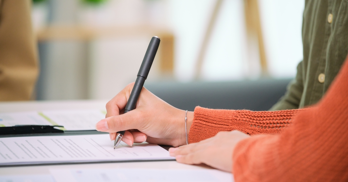 asian couple reviewing and sign contract 