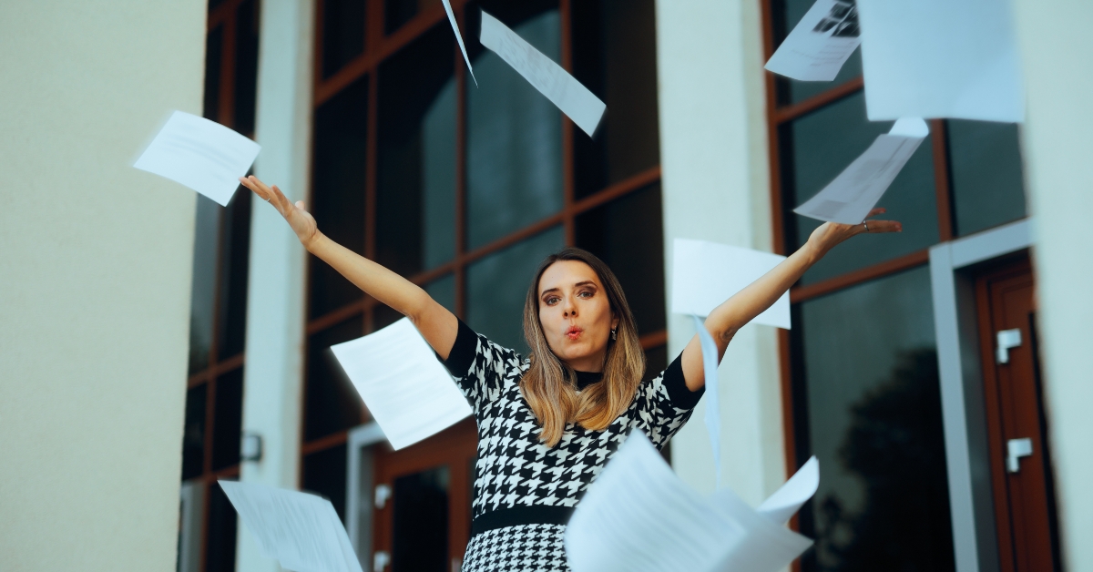 office worker throwing paperwork quitting her job