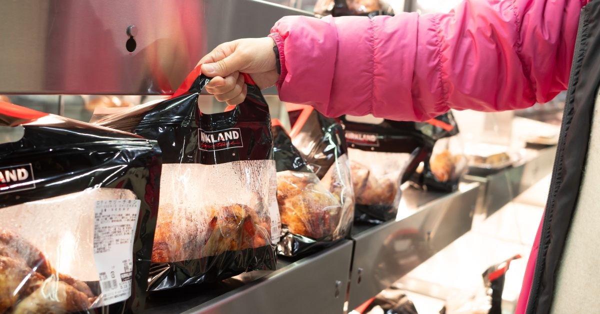 shopper grabs a bag of rotisserie chicken