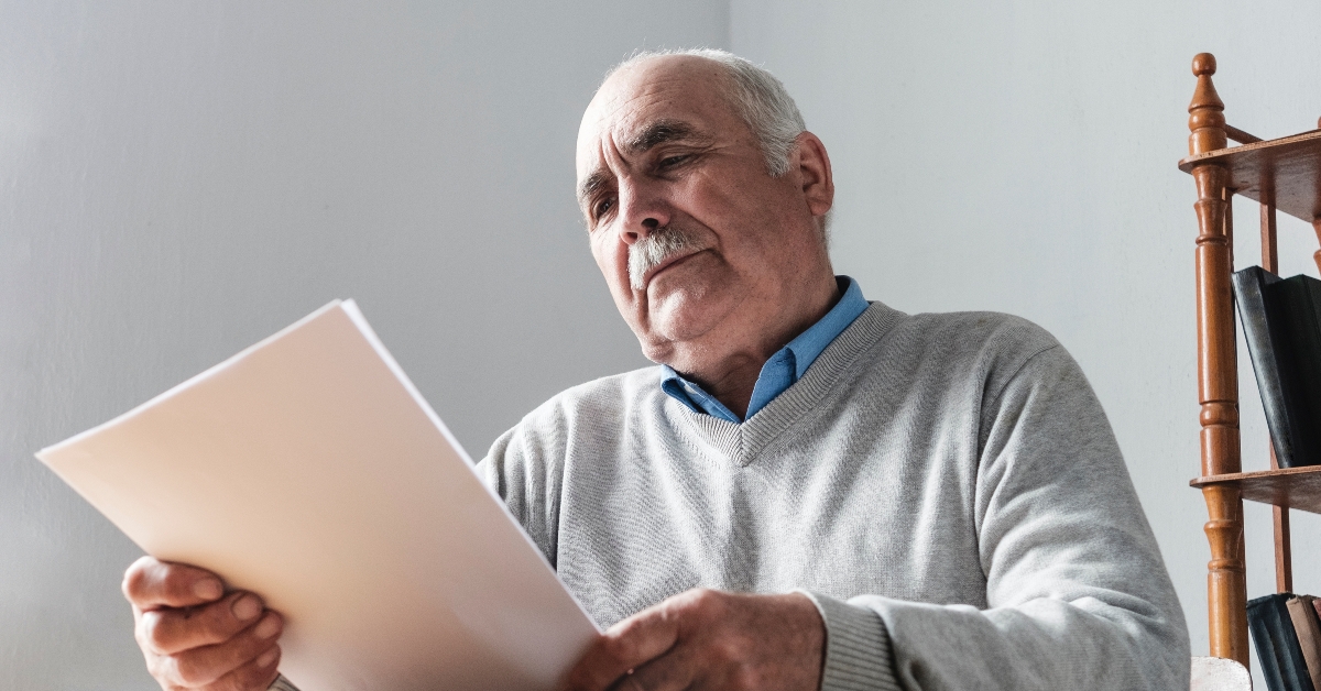 Senior man reading a paper document