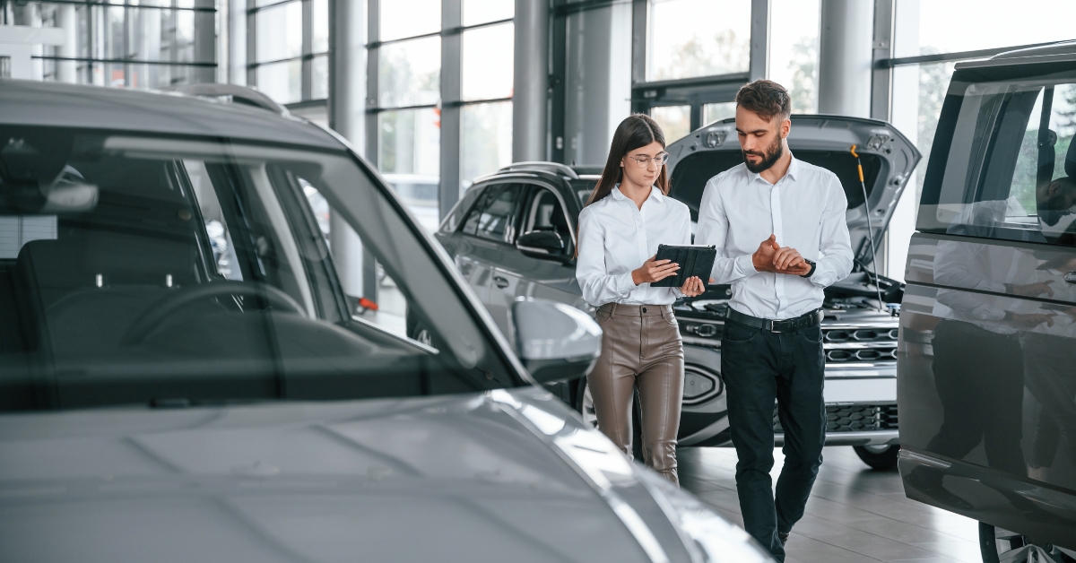 man with woman in the car dealership together