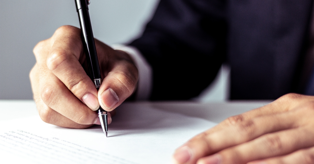 businessman signing a document