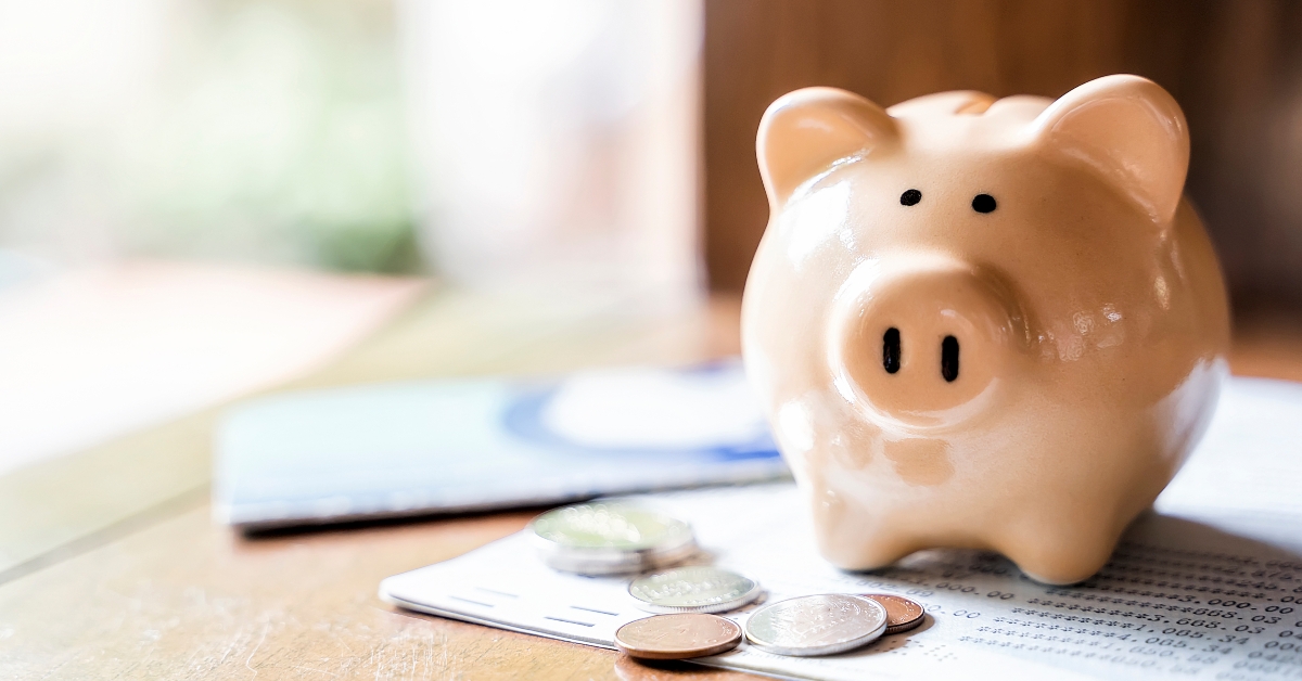 Piggy bank with coins and saving book