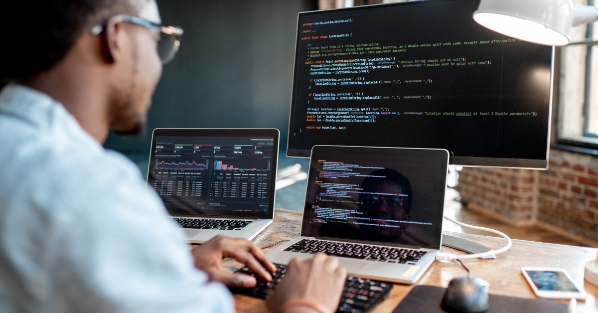 male programmer writing codes