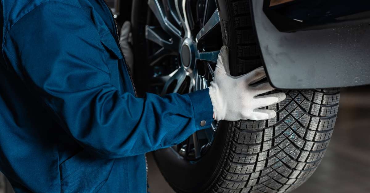 mechanic installing new tire