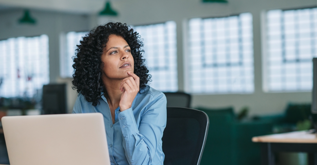 businesswoman thinking while using laptop at work 