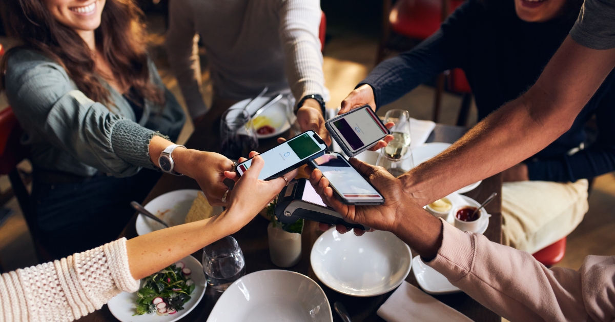 Friends splitting the bill in restaurant