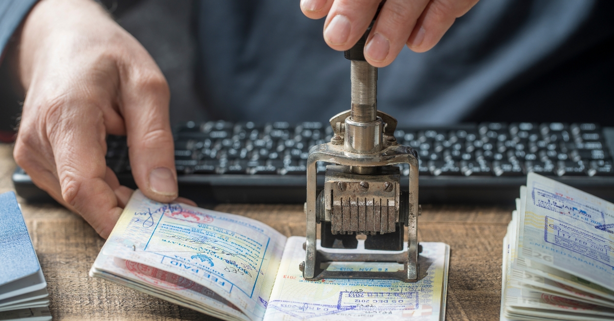 officer puts a stamp in the international passport