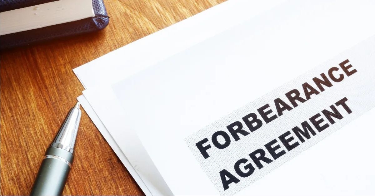 forbearance agreement papers with pen and notepad