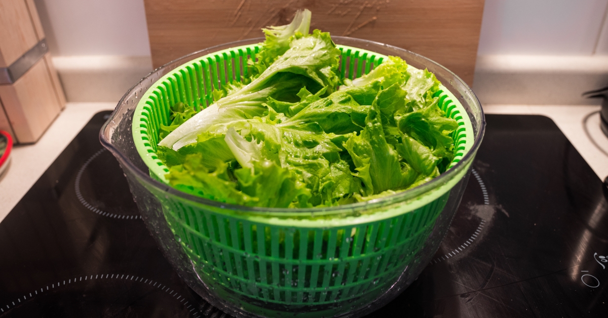 Green salad leaves in a salad spinner