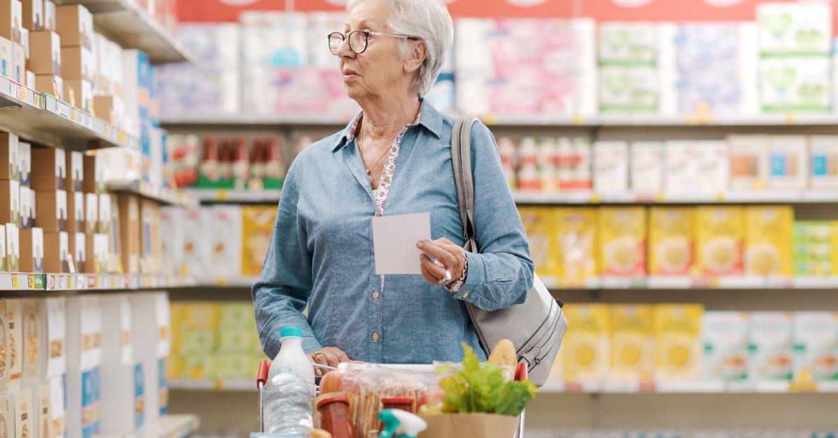 elderly woman buying groceries