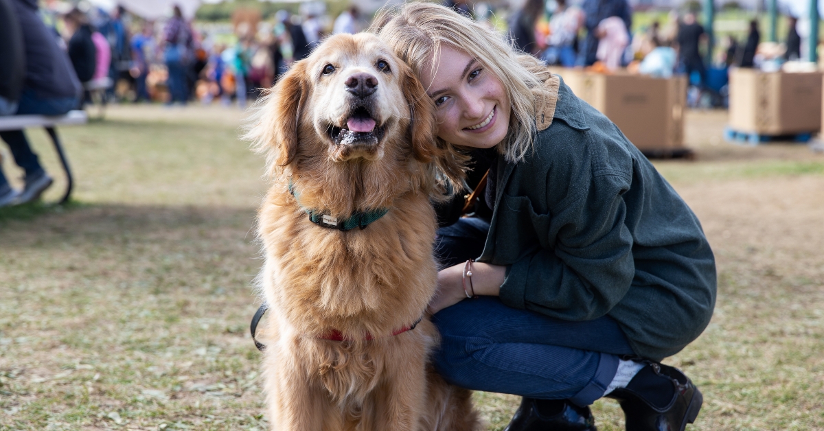 girl smiling with her golden retriever
