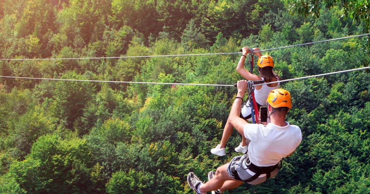 tourists ride on the zipline