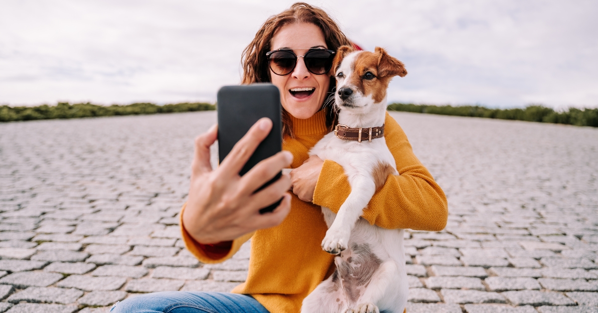 woman sitting in a park with her cute little dog