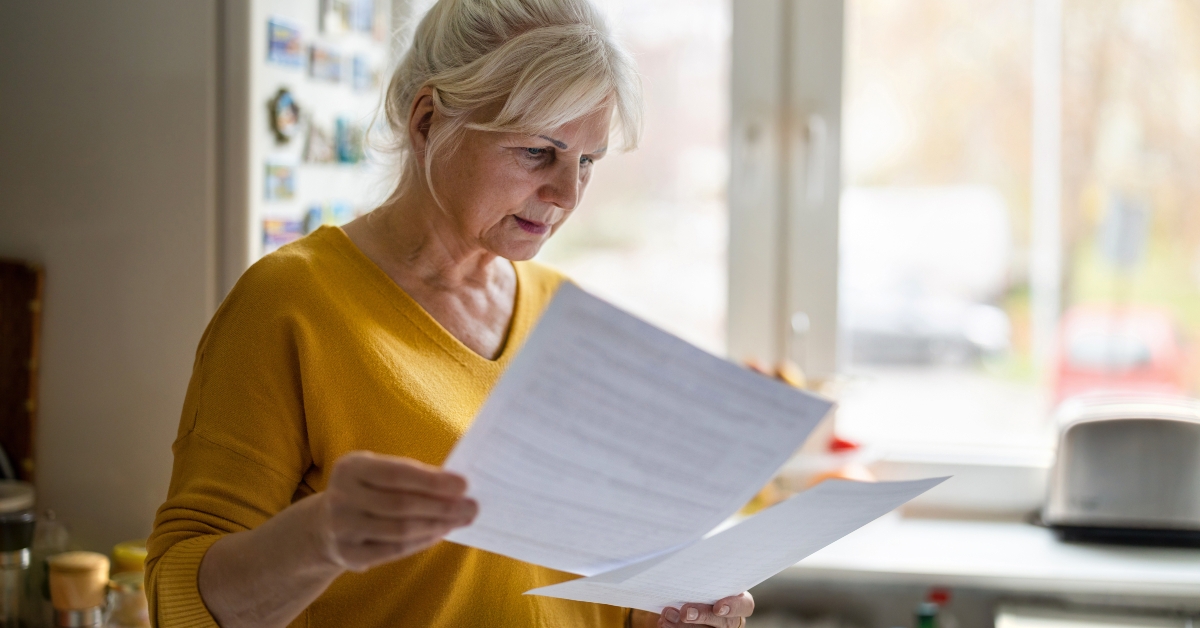 Senior woman filling out financial statements
