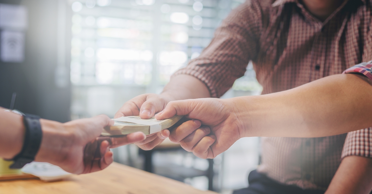 business partners meeting and passing money