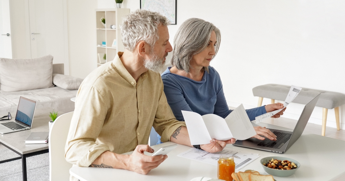 mature couple paying financial bills online