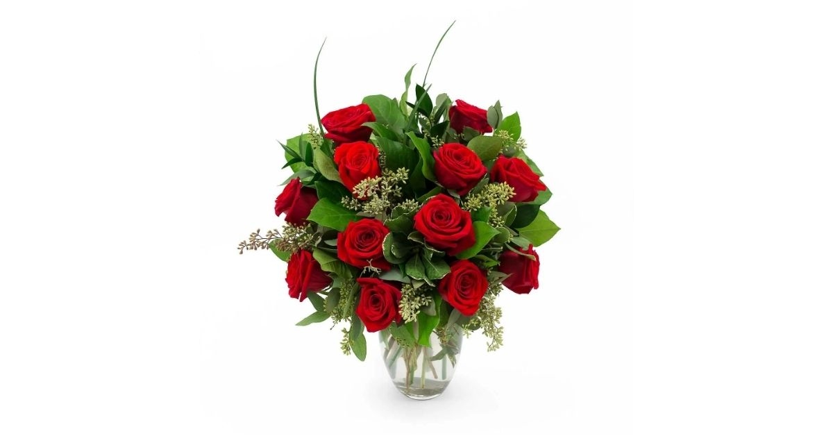 red roses and greenery vase arrangement