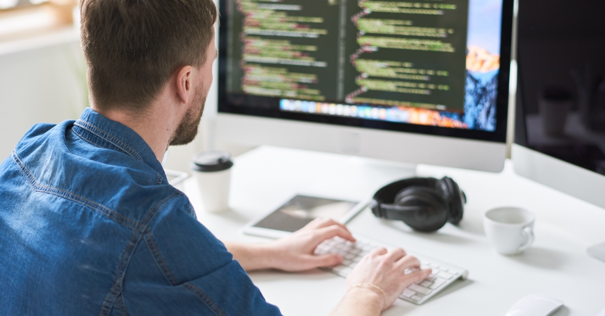 male web developer writing code