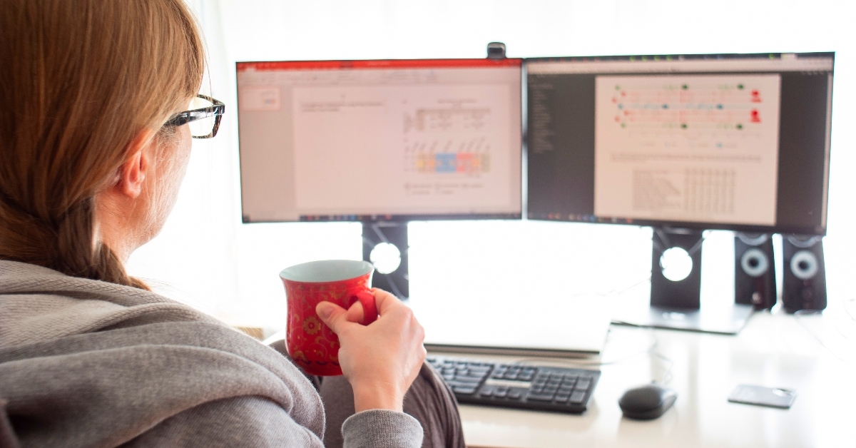 woman drinking coffee working from home