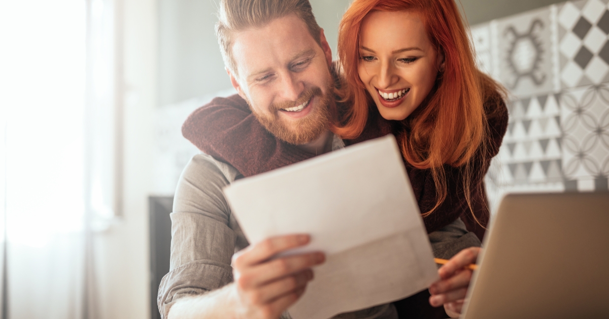 happy couple reading documents together