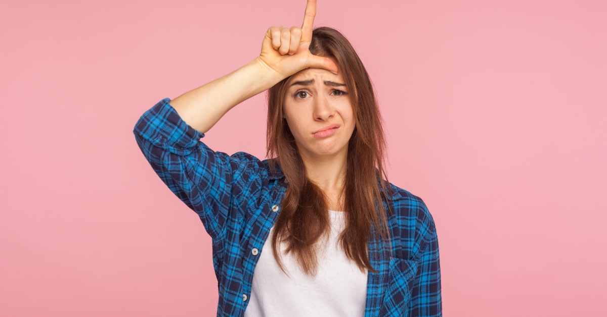 woman showing loser gesture with fingers