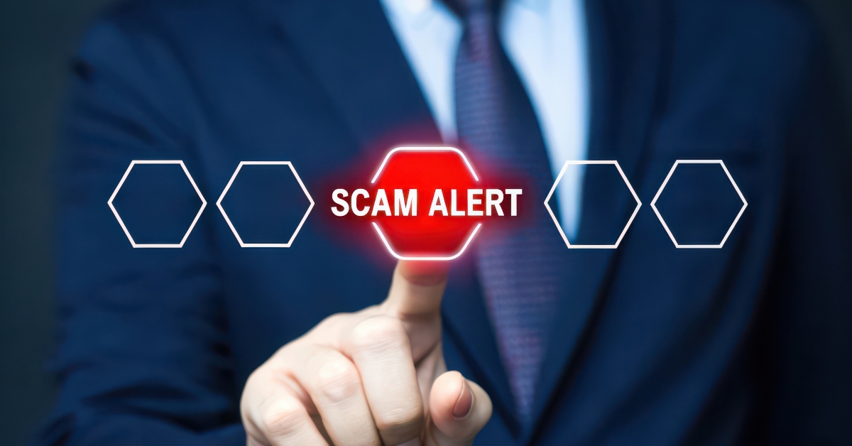 businessman pointing scam alert warning on screen