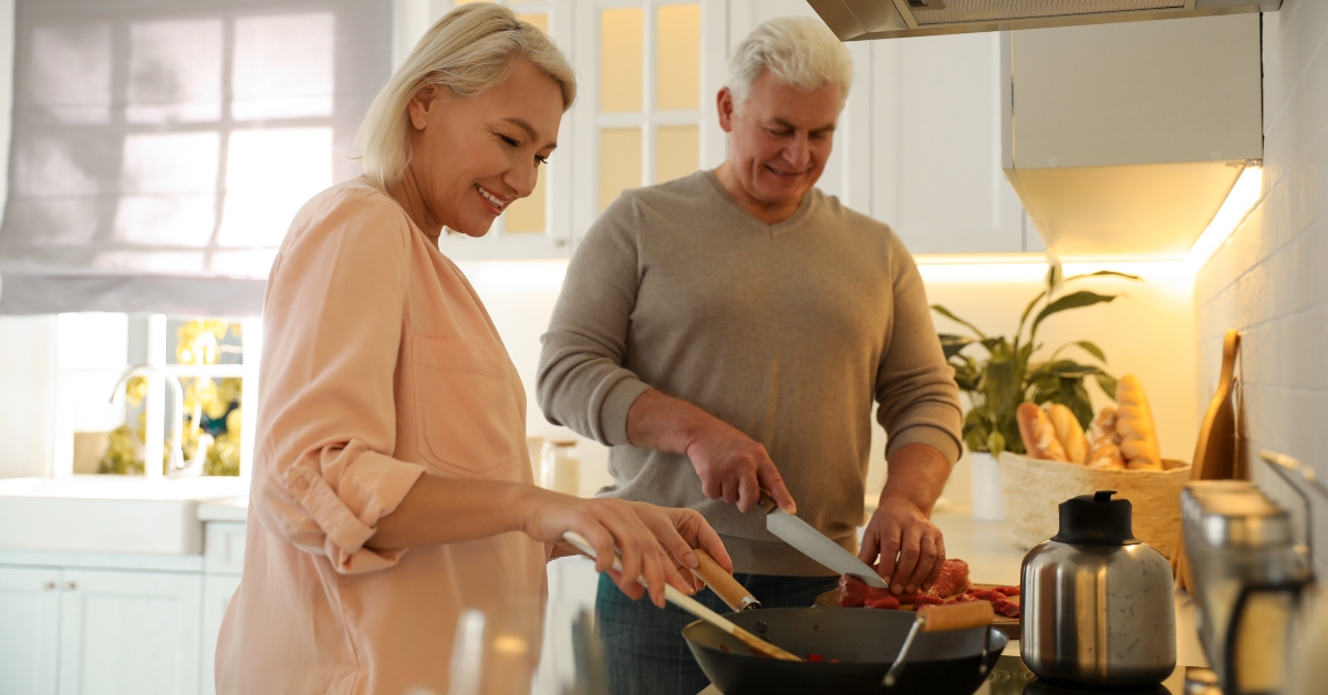 mature couple cooking food together
