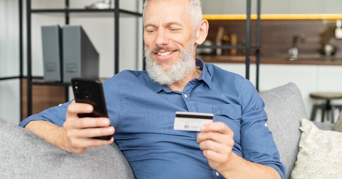 mature man holding smartphone