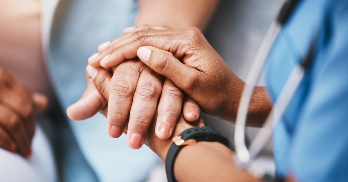  nurse holding hands of patient