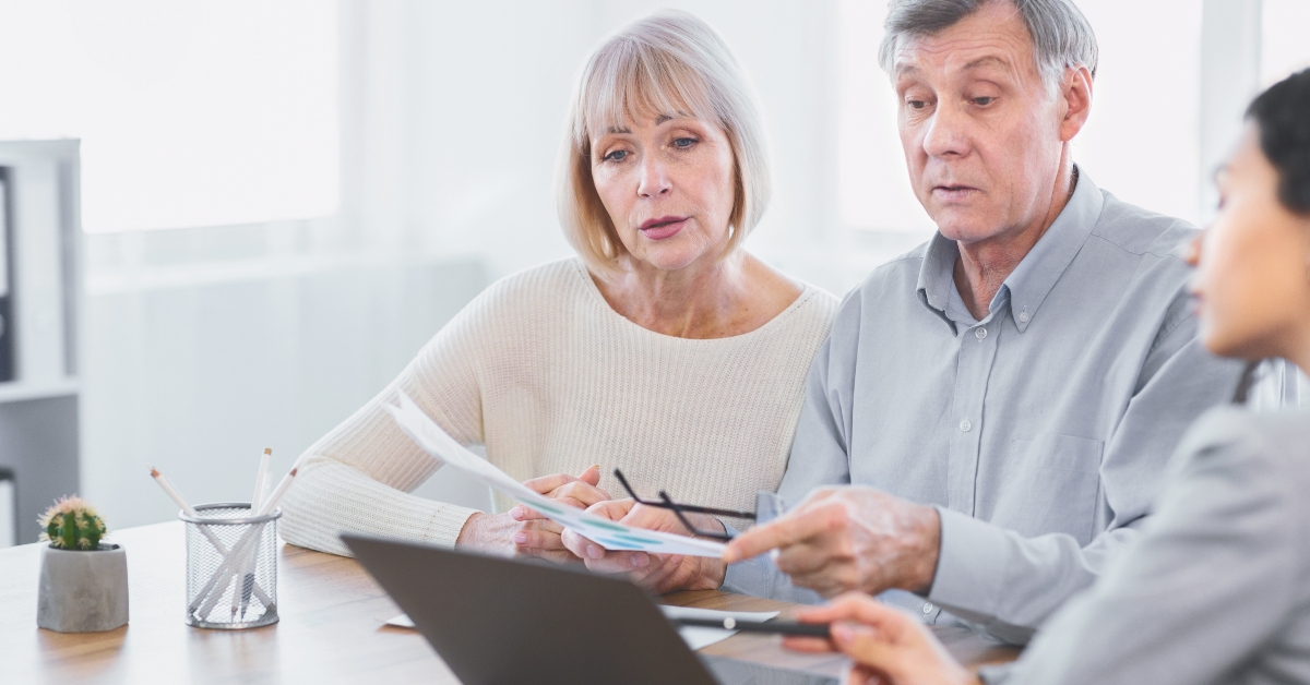 mature couple talking to financial advisor