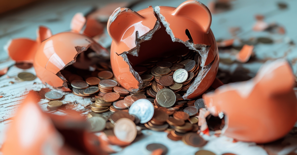 Broken Piggy Bank With Coins Spilling Out